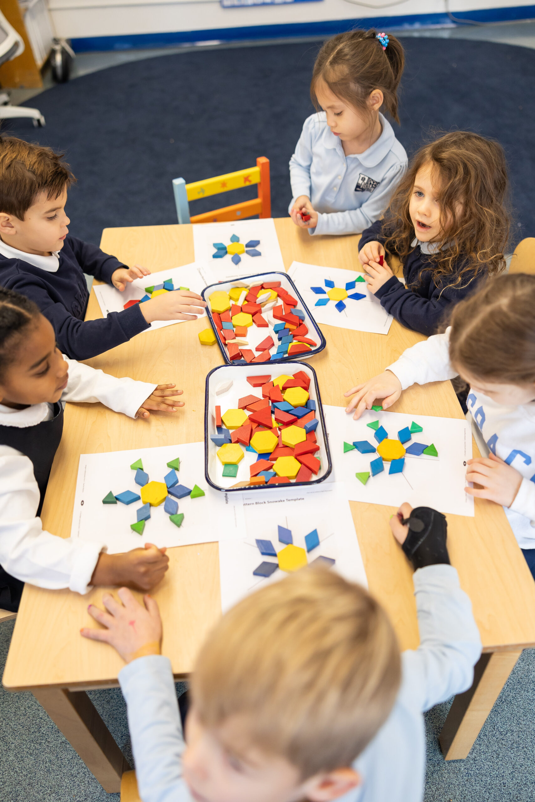 Early childhood students working with geometric blocks.