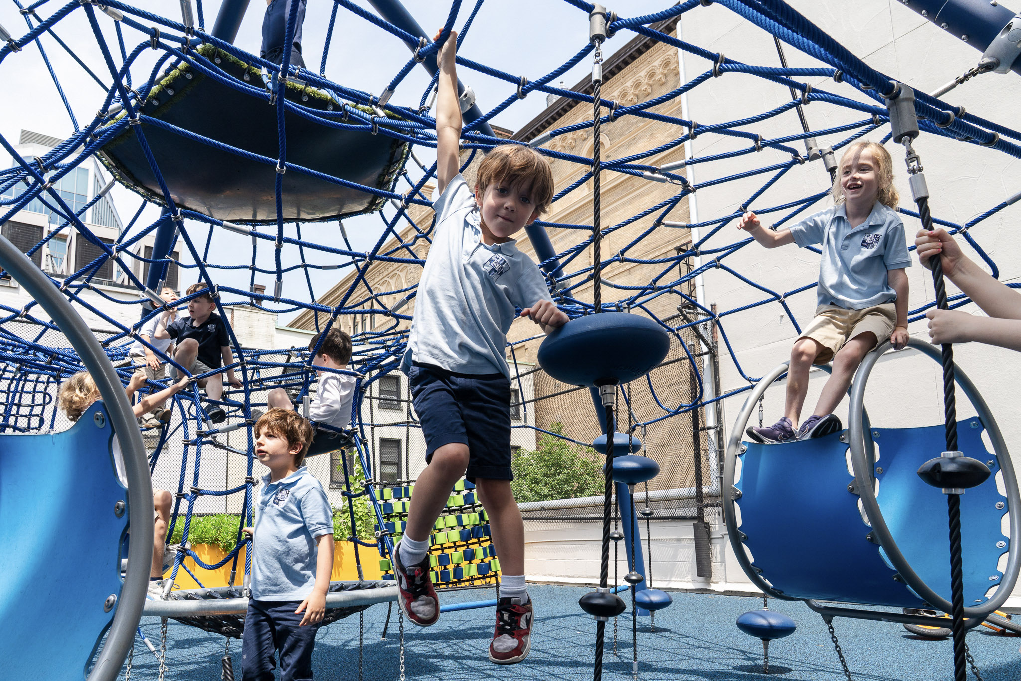Child hanging from play structure.
