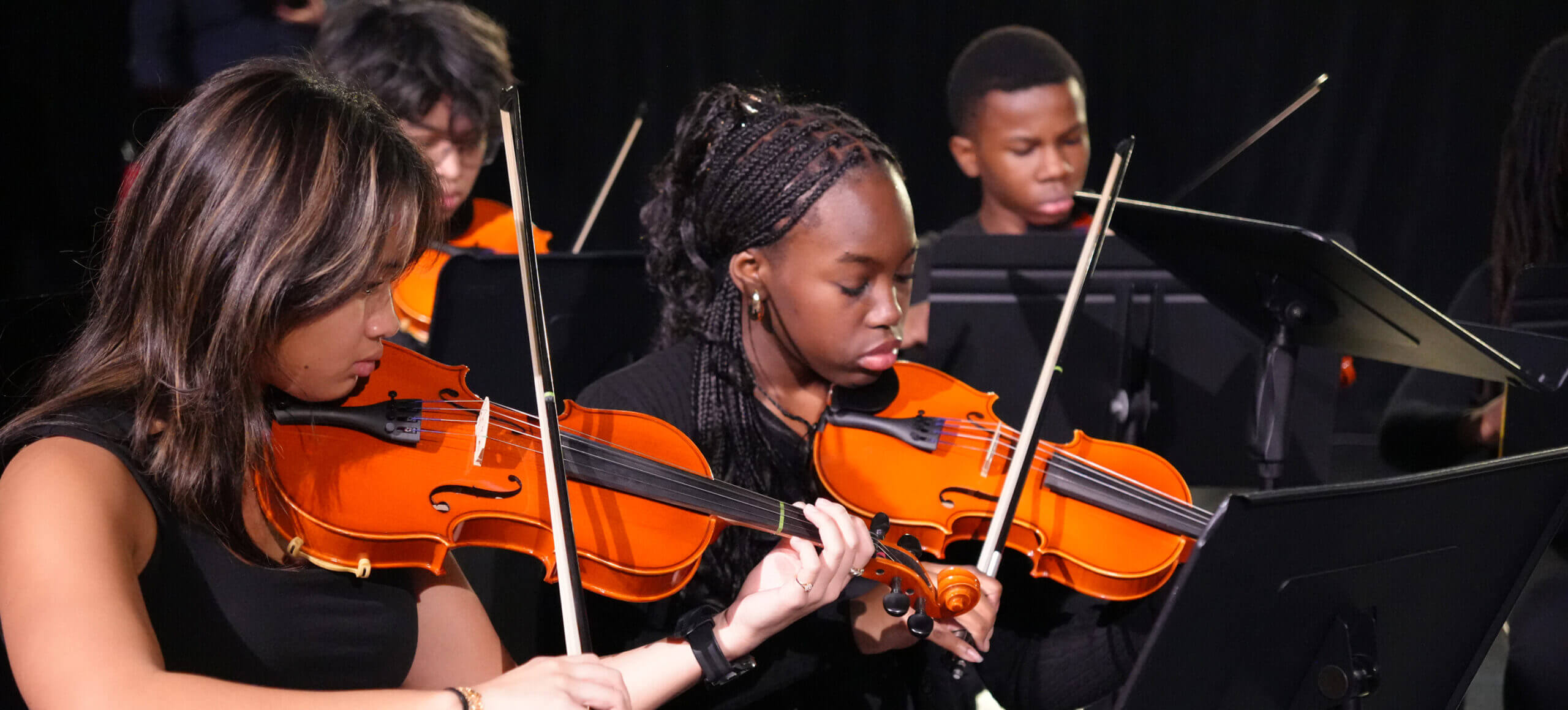 High School students playing stringed orchestra instruments