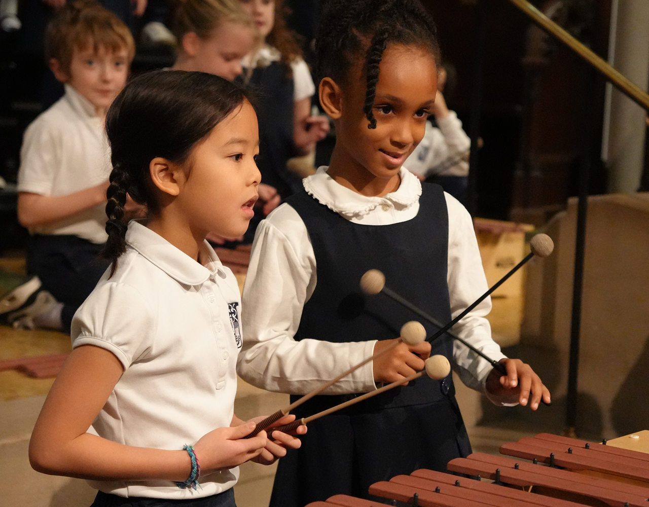 Lower School students playing a marimba in music class
